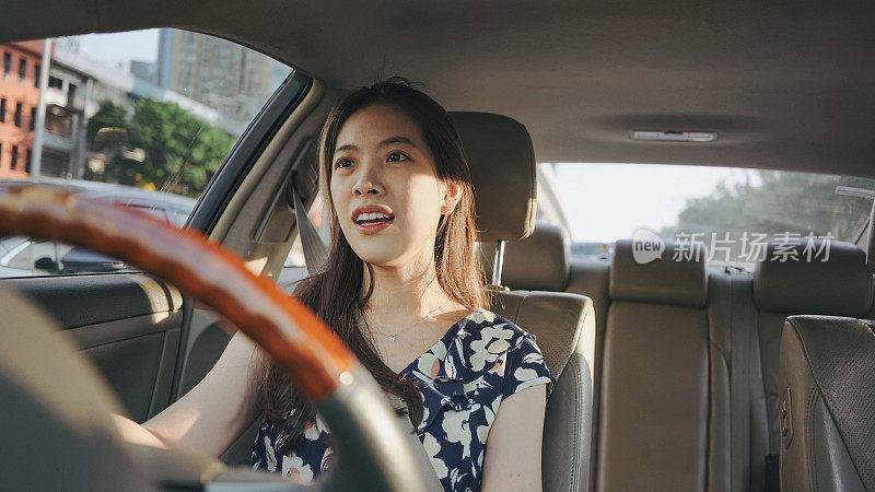 Asian woman talking by wireless earphone feeling bored during driving car in bangkok thailand going to working in morning